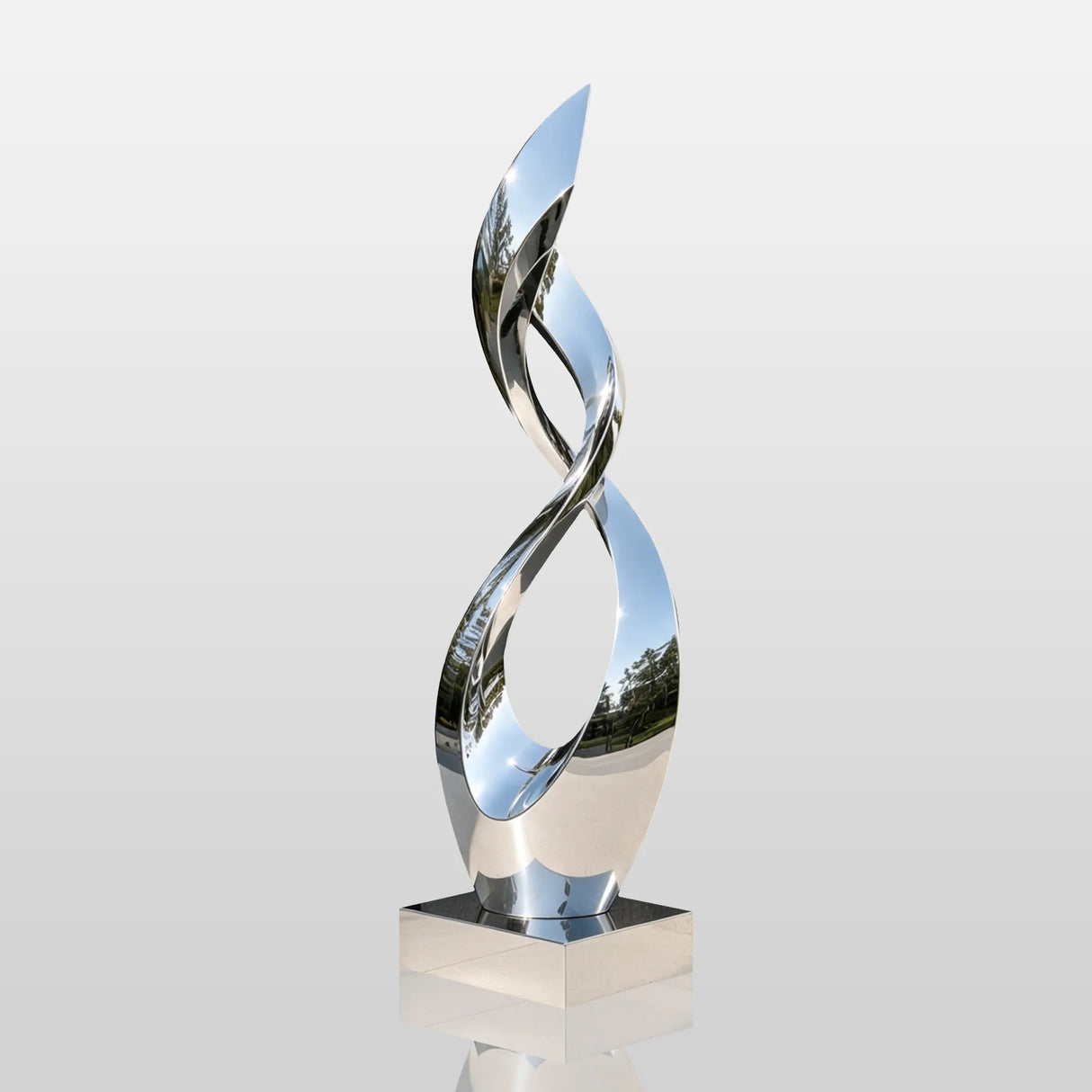 Mirror polished stainless steel twisted sculpture stands by a modern building.
