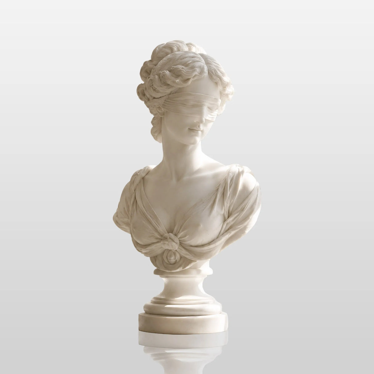 Marble blindfolded lady bust stands on a bright bedroom windowsill.