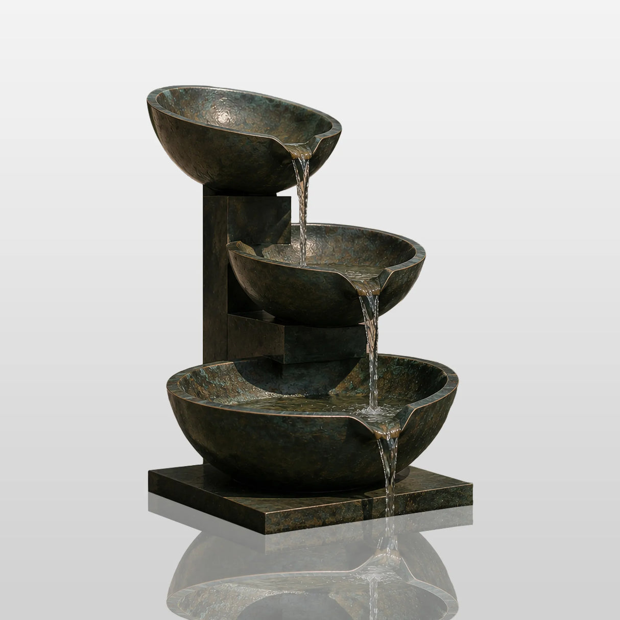 Three tier bronze bowl fountain sits outdoors with water flowing down each bowl.