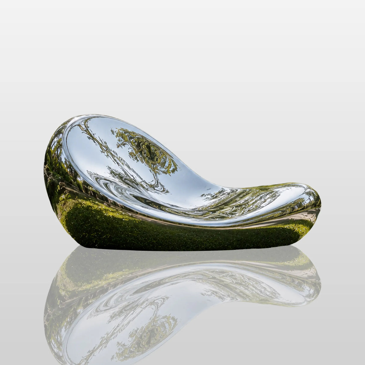 A mirror polished organic curved stainless steel bench rests on lush lawn under sun.