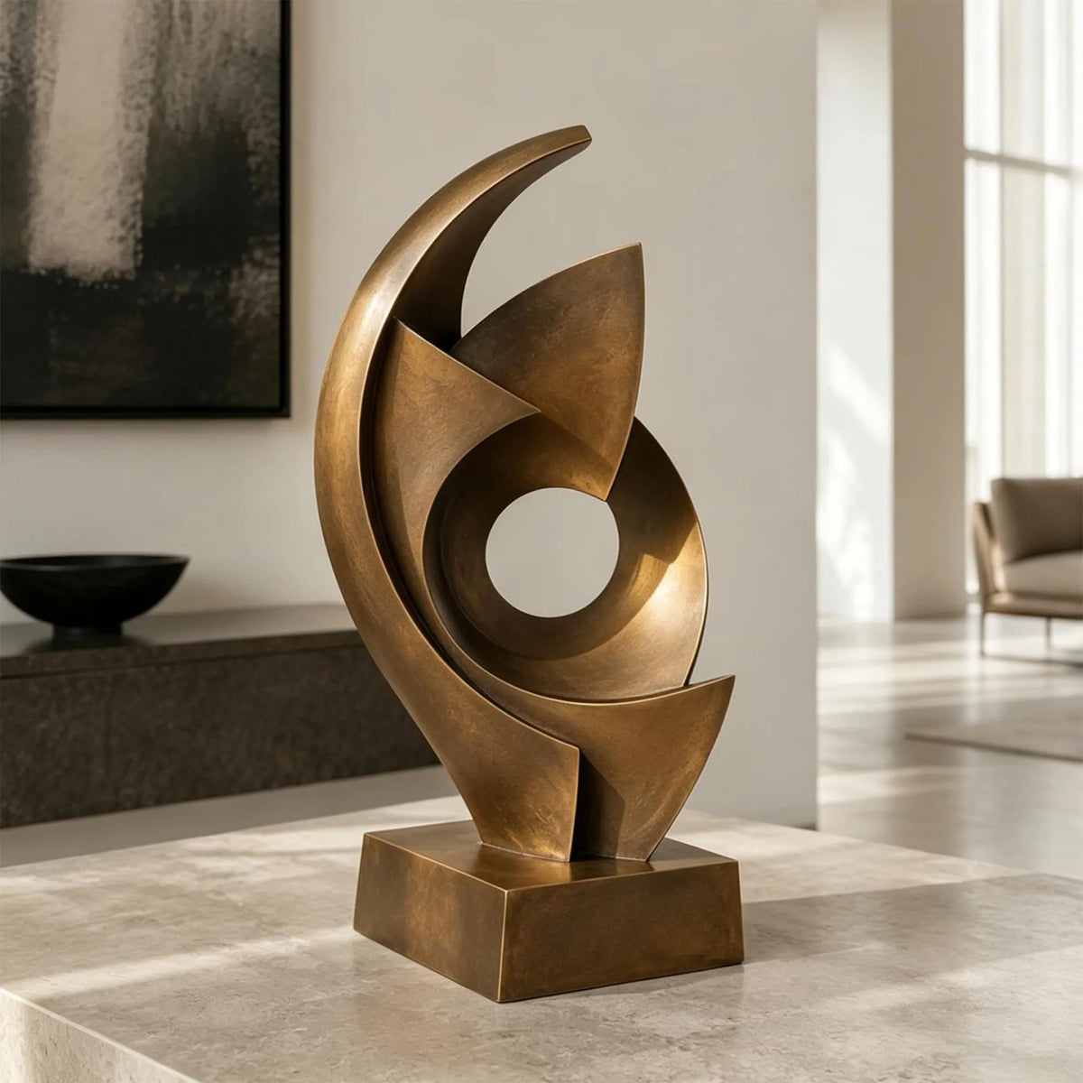 An abstract swirling bronze sculpture sits in a bright modern home.