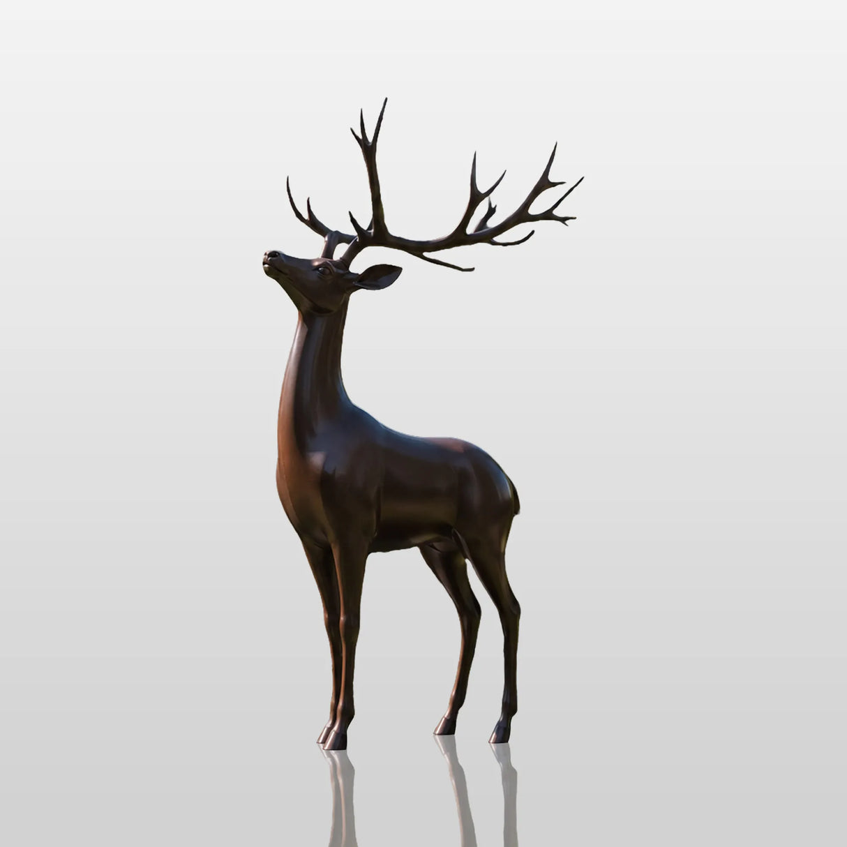 Bronze deer statue stands on the green lawn in front of a residential house.