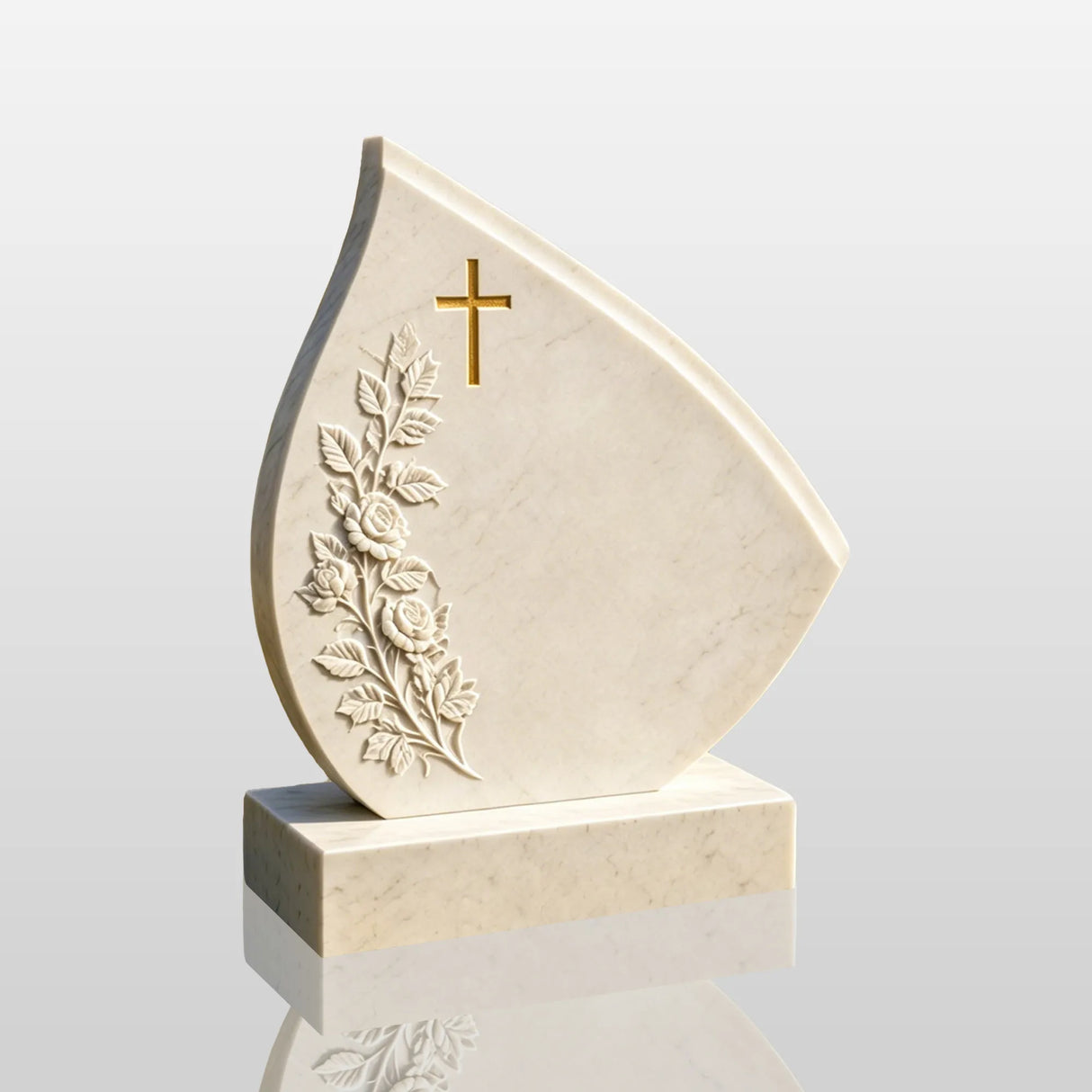 Teardrop marble tombstone engraved with golden cross and rose carvings stands on the cemetery lawn.