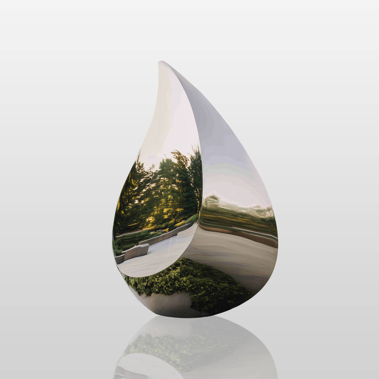 The mirrored water droplet sculpture in reflective stainless steel, blending with pine forests and sky, ideal for eco parks or lawn.