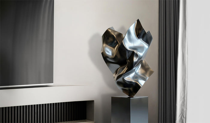 Modern abstract heart-shaped sculpture made of polished stainless steel