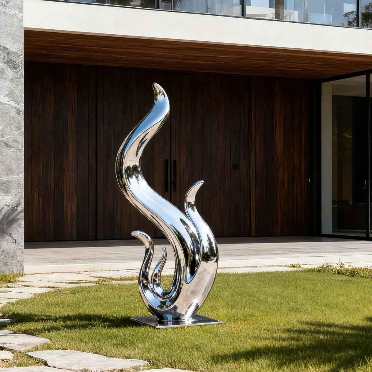 Abstract stainless steel flame sculpture with fluid wave like curves and a polished mirror finish displayed in a modern villa garden.