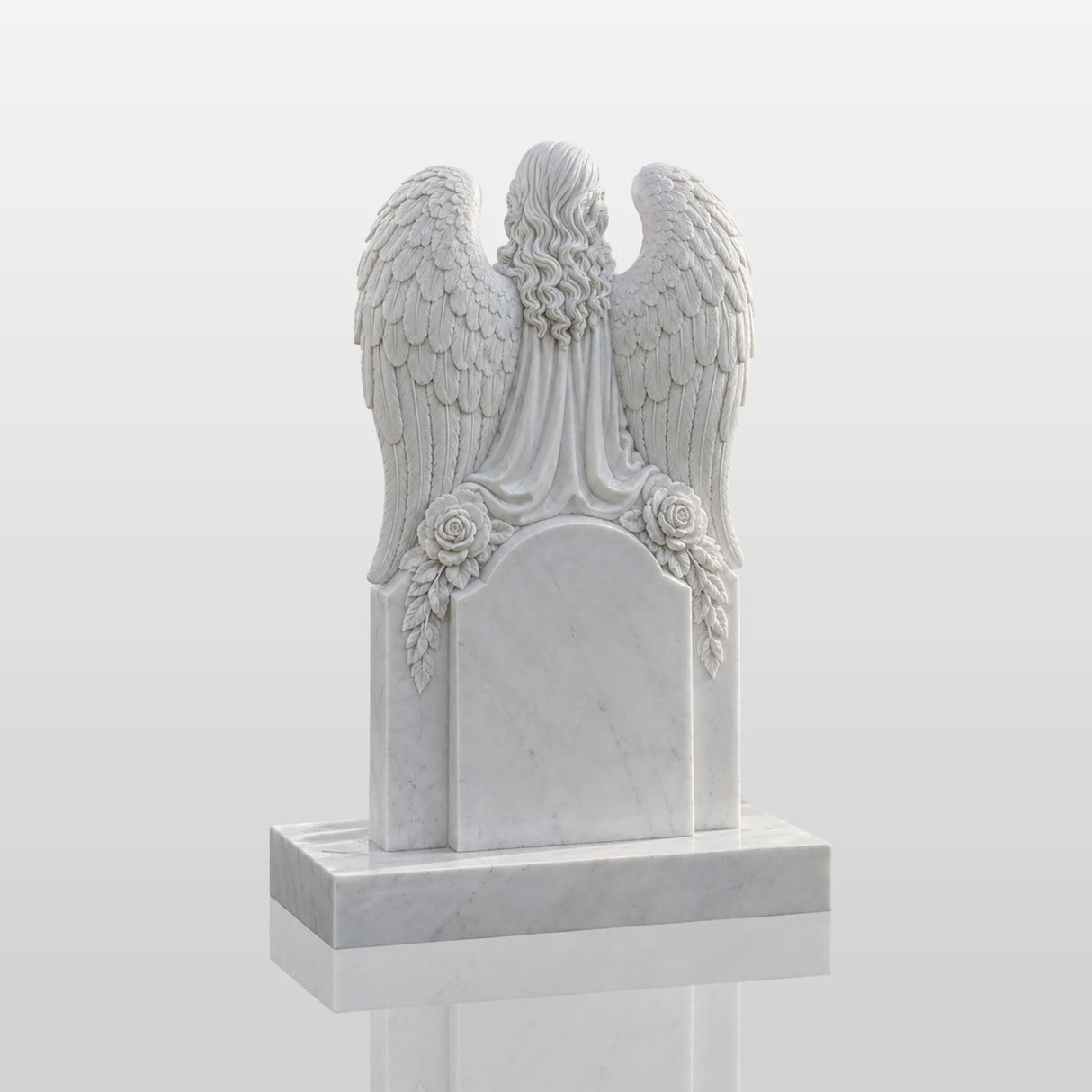 Marble tombstone carved with praying angel, roses and heart stands on the lush green cemetery lawn.