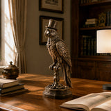 Antique bronze parrot sculpture rests on a study desk beside stacked books and open reading volume.