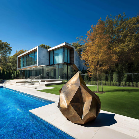 Abstract golden bronze sculpture with rock-like irregular form and gradient surface, ideal for modern outdoor or interior art spaces.
