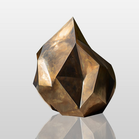 Abstract golden bronze sculpture with rock-like irregular form and gradient surface, ideal for modern outdoor or interior art spaces.