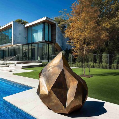 Abstract golden bronze sculpture with rock-like irregular form and gradient surface, ideal for modern outdoor or interior art spaces.