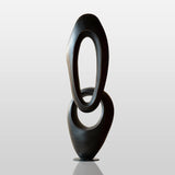 Flowing oval-shaped bronze sculpture with black finish