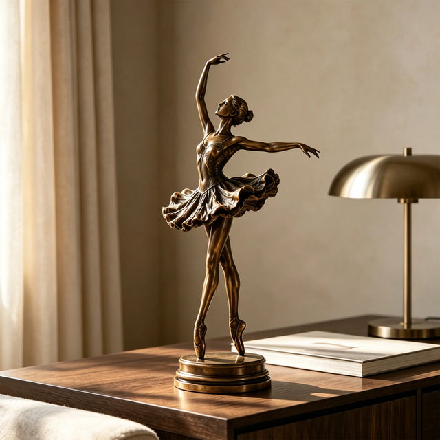 Bronze ballerina table sculpture stands on the wooden desk under soft indoor sunlight.