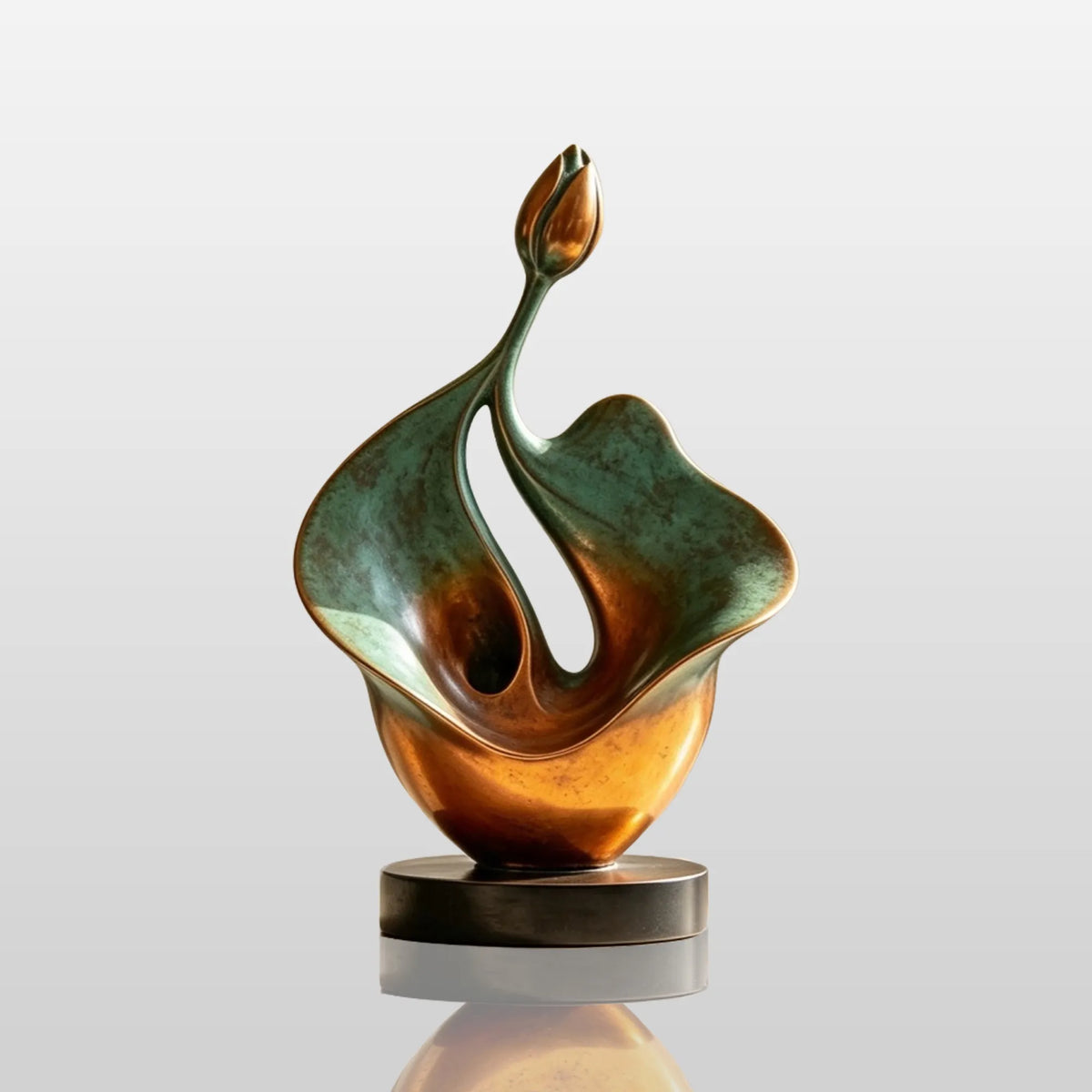 An abstract bronze lotus sculpture is set on a light table indoors.