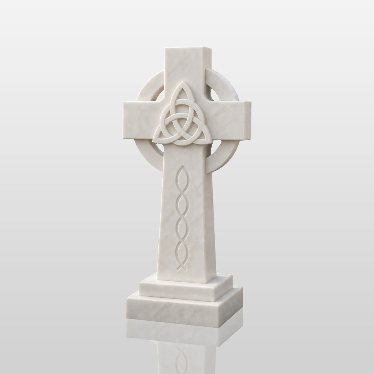 The marble Celtic cross headstone sits on dark gravel among green garden shrubs.