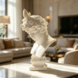 A white marble male bust sculpture is displayed on a tabletop in an elegant contemporary living room.