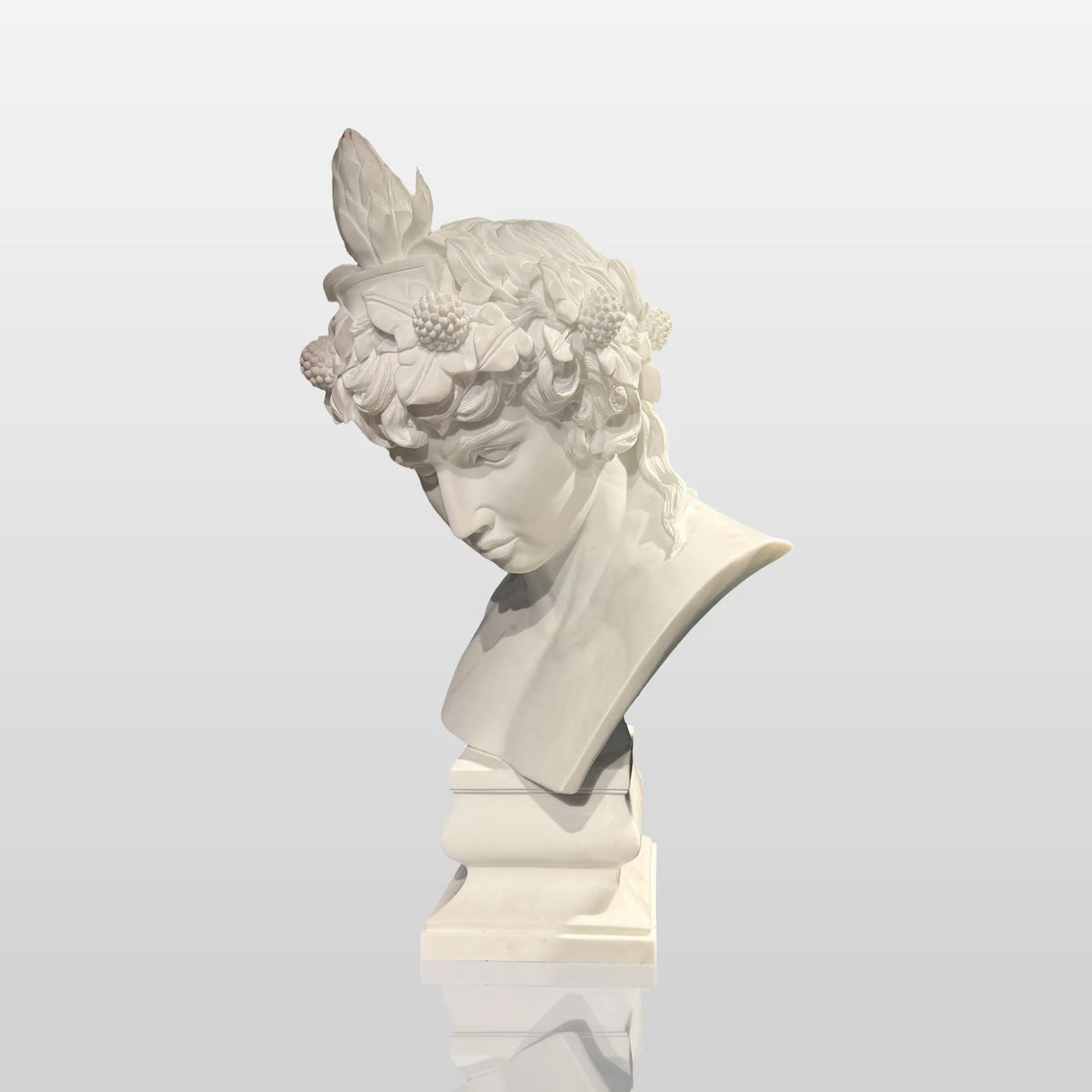 A white marble male bust sculpture is displayed on a tabletop in an elegant contemporary living room.