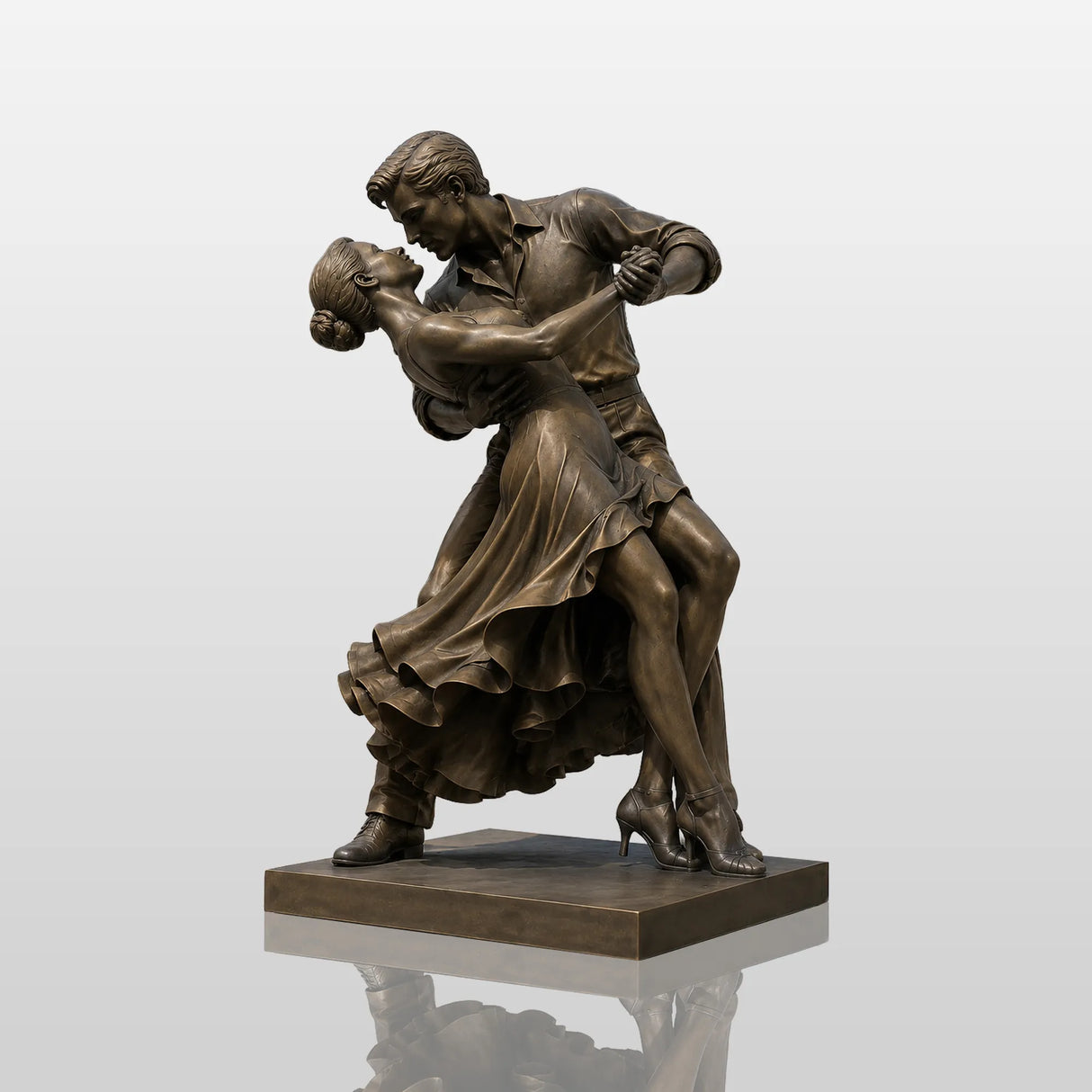 Bronze dancing couple sculpture stands on paved stone plaza beside a city fountain.