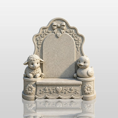 Granite tombstone with carved lamb and duck sits in a memorial garden under sunshine.