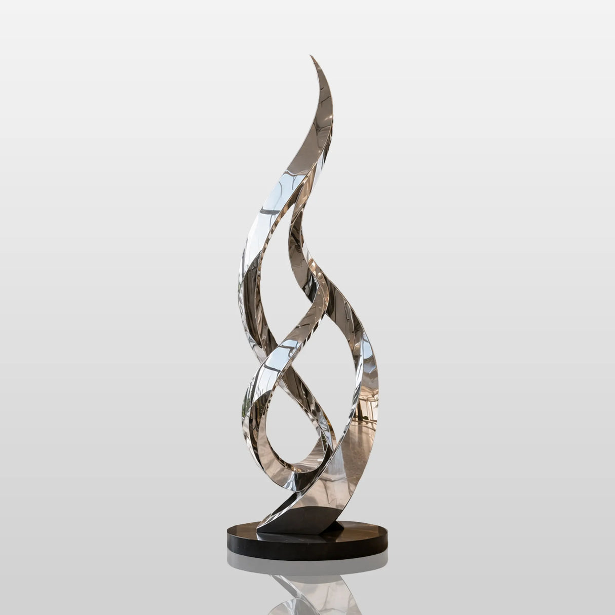 The tall twisted stainless steel sculpture stands in spacious double height luxury hotel lobby.
