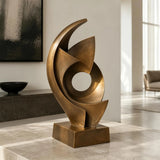 An abstract swirling bronze sculpture sits in a bright modern home.
