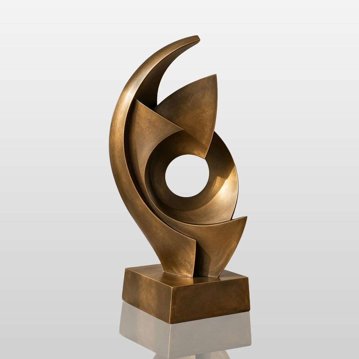 An abstract swirling bronze sculpture sits in a bright modern home.