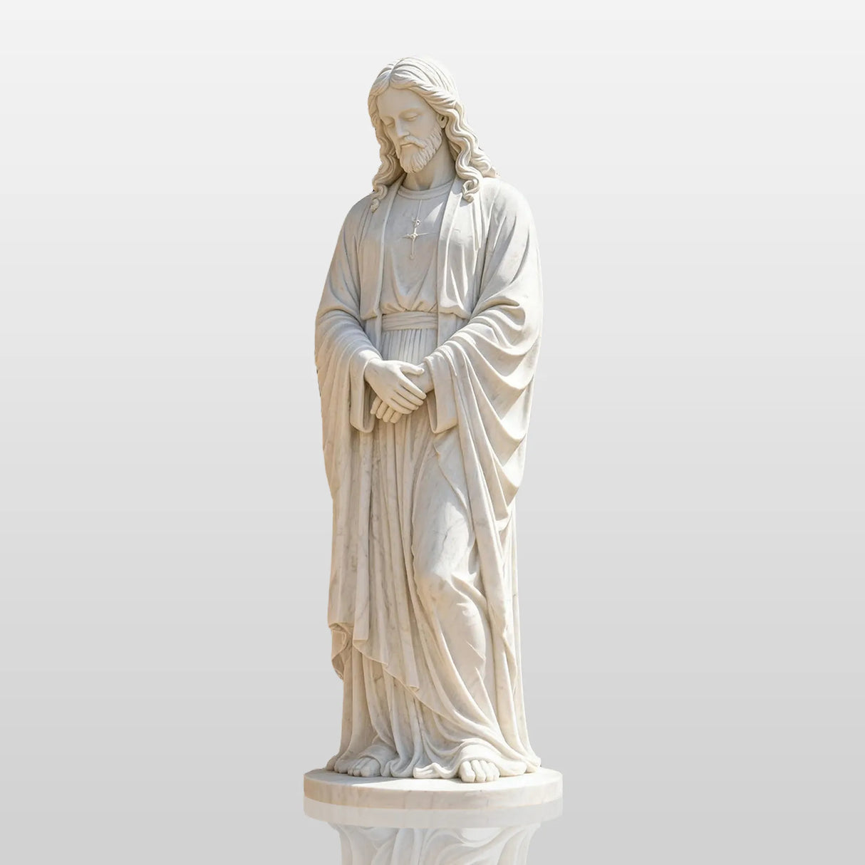 White marble Jesus statue stands on stone pavement beside a church building.