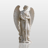 Marble Saint Michael statue stands in a garden with classical columned mansion and tall cypress trees behind.
