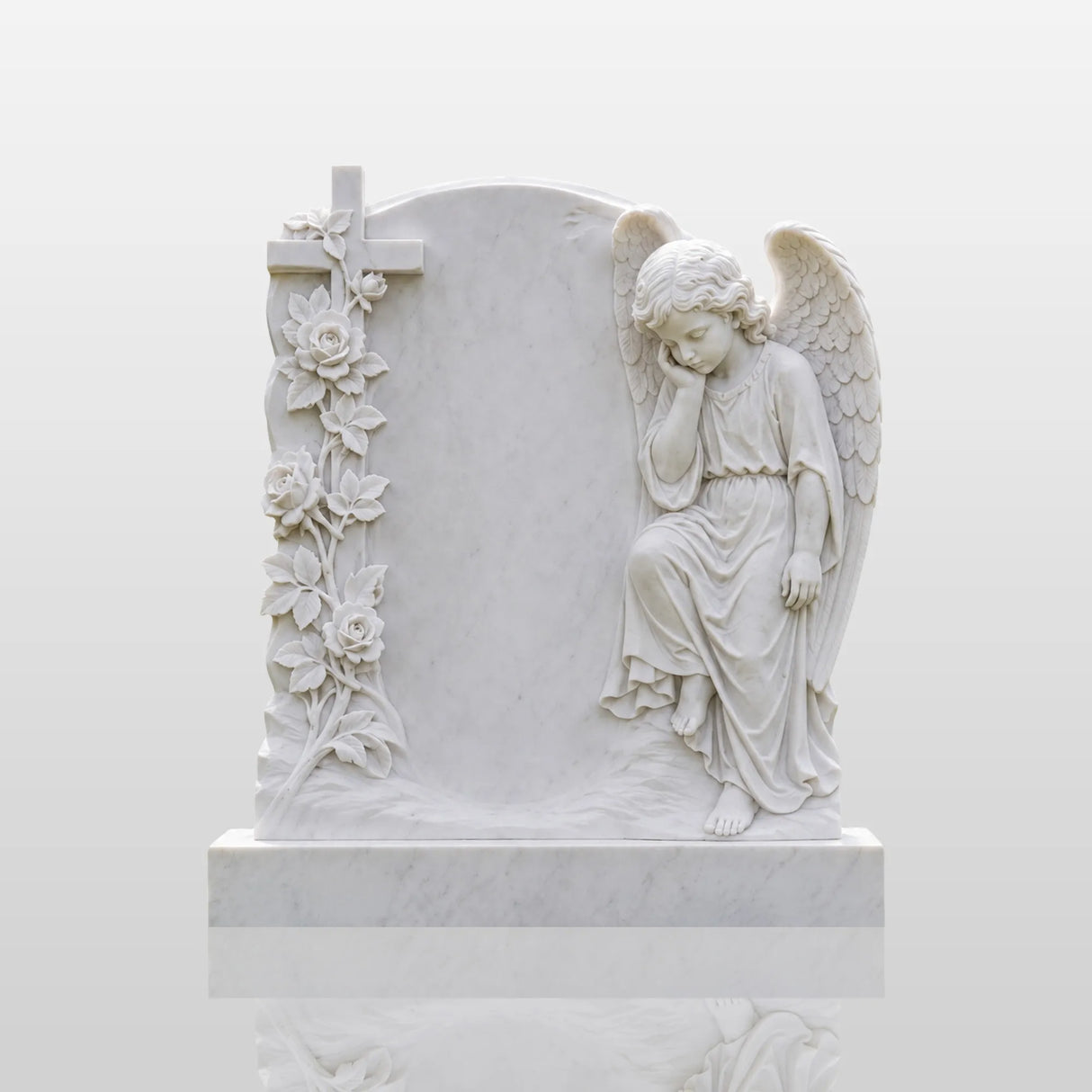 White marble cherub tombstone carved with roses sits on the a green cemetery lawn.