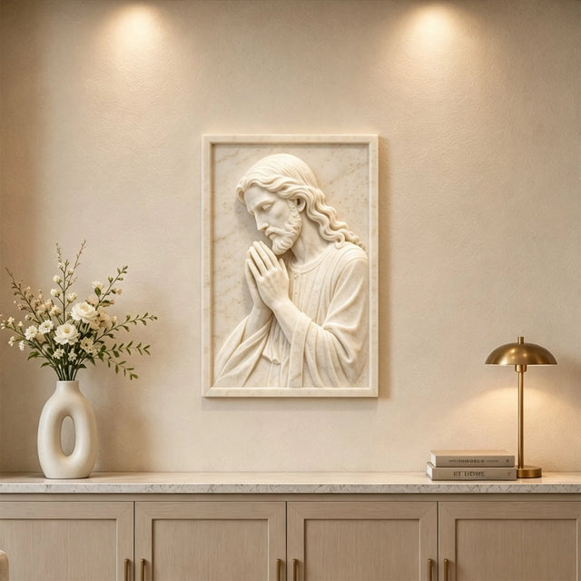 Marble relief of praying Jesus hangs on the wall in bright home interior.