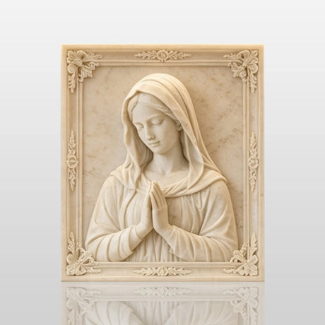 Marble Virgin Mary wall relief sculpture displayed on lit built in shelving indoors.