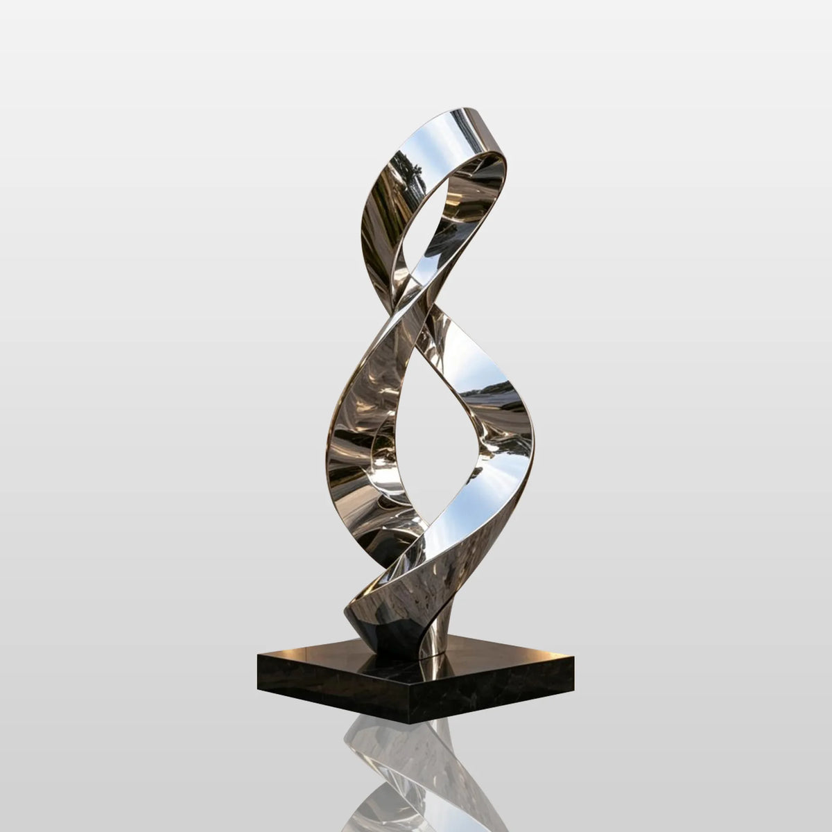 A shiny stainless steel sculpture with infinity loop design stands on paved ground outside a building.