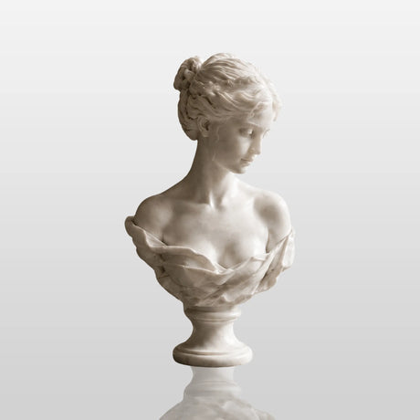 White marble female bust statue sits on a dark marble table in a refined indoor room.