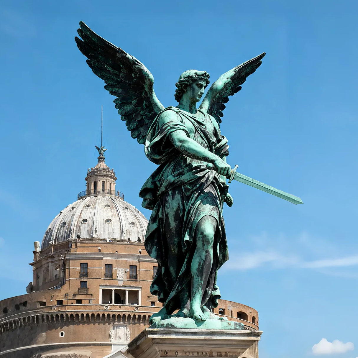 Bronze Saint Michael statue stands on stone pedestal in front of a domed building.