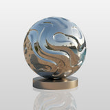 Polished stainless steel abstract sphere sculpture beside a pool at a modern residence