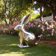 Polished stainless steel rabbit sculpture with mirror surface for modern garden or outdoor art display.