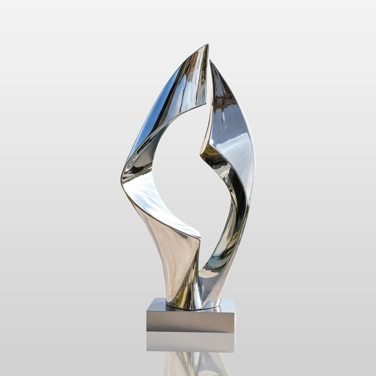 Polished loop stainless steel sculpture stands beside a swimming pool.