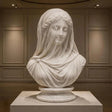Exquisitely carved translucent veiled lady marble bust sits inside a muted paneled art gallery room.