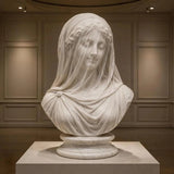 Exquisitely carved translucent veiled lady marble bust sits inside a muted paneled art gallery room.