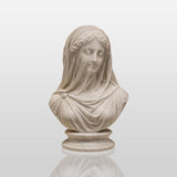 Exquisitely carved translucent veiled lady marble bust sits inside a muted paneled art gallery room.