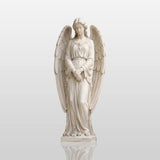 White marble angel statue with wings stands on tiered marble pedestal beside tall stone wall.