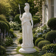 White marble Athena statue stands on a pedestal amid the garden plantings.